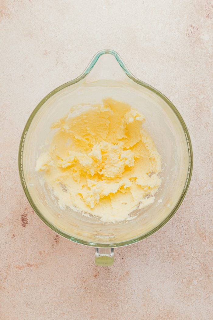 Creamed butter in a glass mixing bowl.
