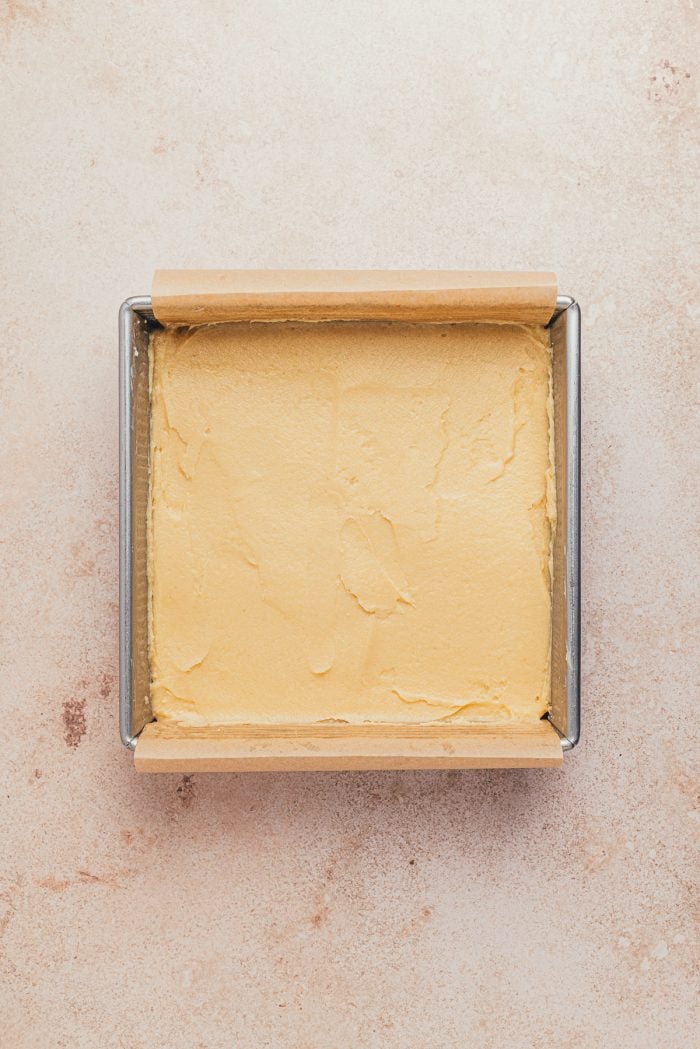 The cake batter poured into a prepared cake pan.