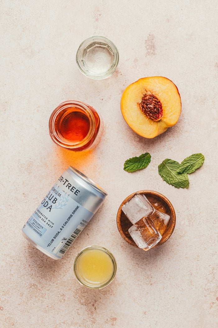 The ingredients to make a bourbon peach smash.