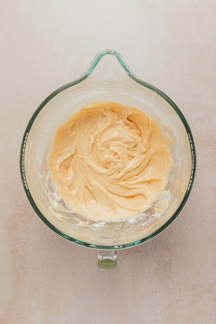 A mixing bowl with cake batter in it.