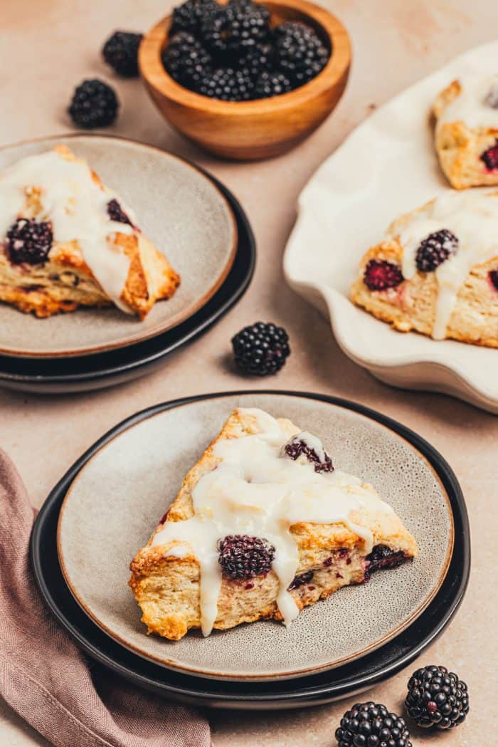 Plates with a glazed blackberry scone.
