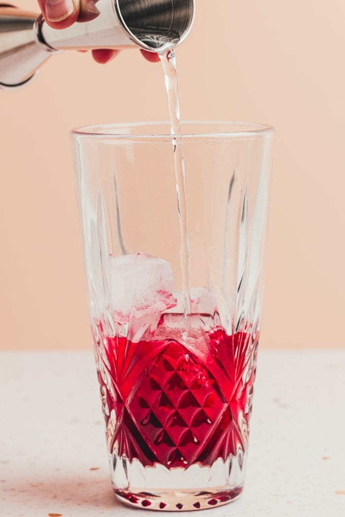 A glass filled with blueberry syrup.