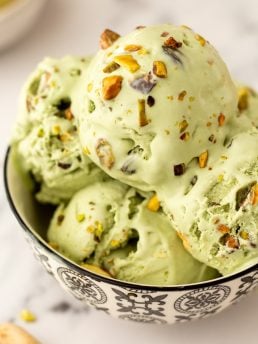 A bowl with many scoops of no churn Pistachio Ice cream.