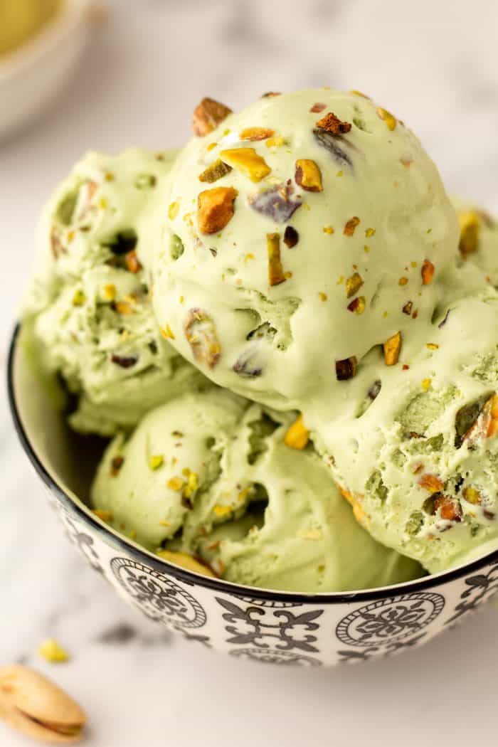 A bowl with many scoops of no churn Pistachio Ice cream.