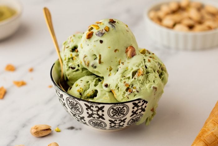 A bowl with many scoops of no churn Pistachio Ice cream.