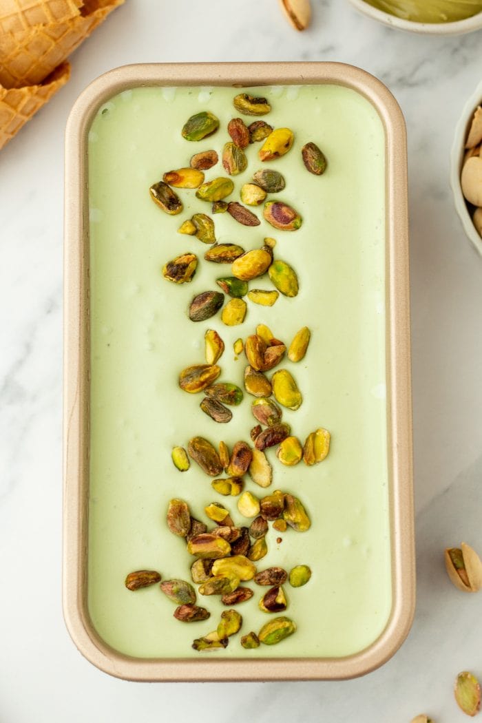 A loaf pan with homemade pistachio ice cream.