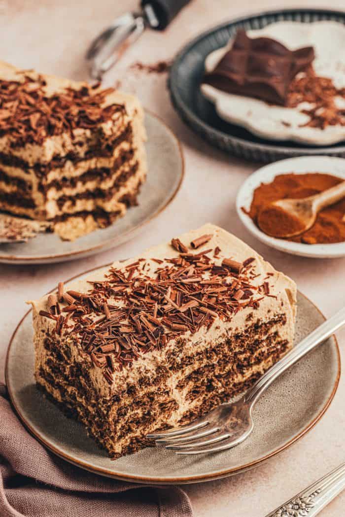 A slice of the homemade espresso icebox cake on a plate with another slice on a plate in the background.