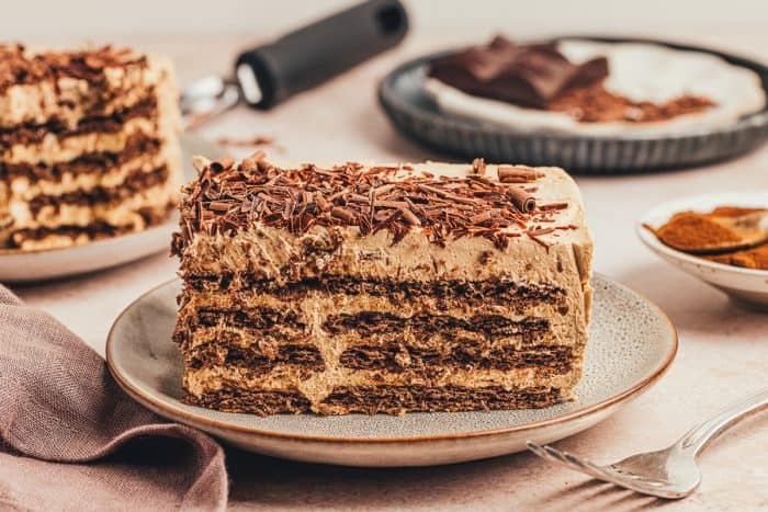 A slice of chocolate espresso icebox cake on a plate showing the layers.