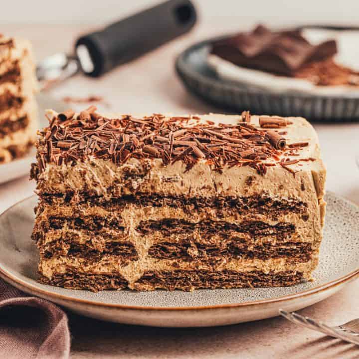 A slice of chocolate espresso icebox cake on a plate showing the layers.