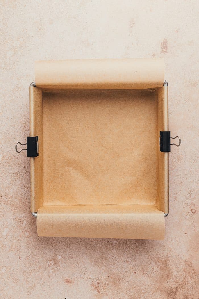 A square baking pan with parchment paper.