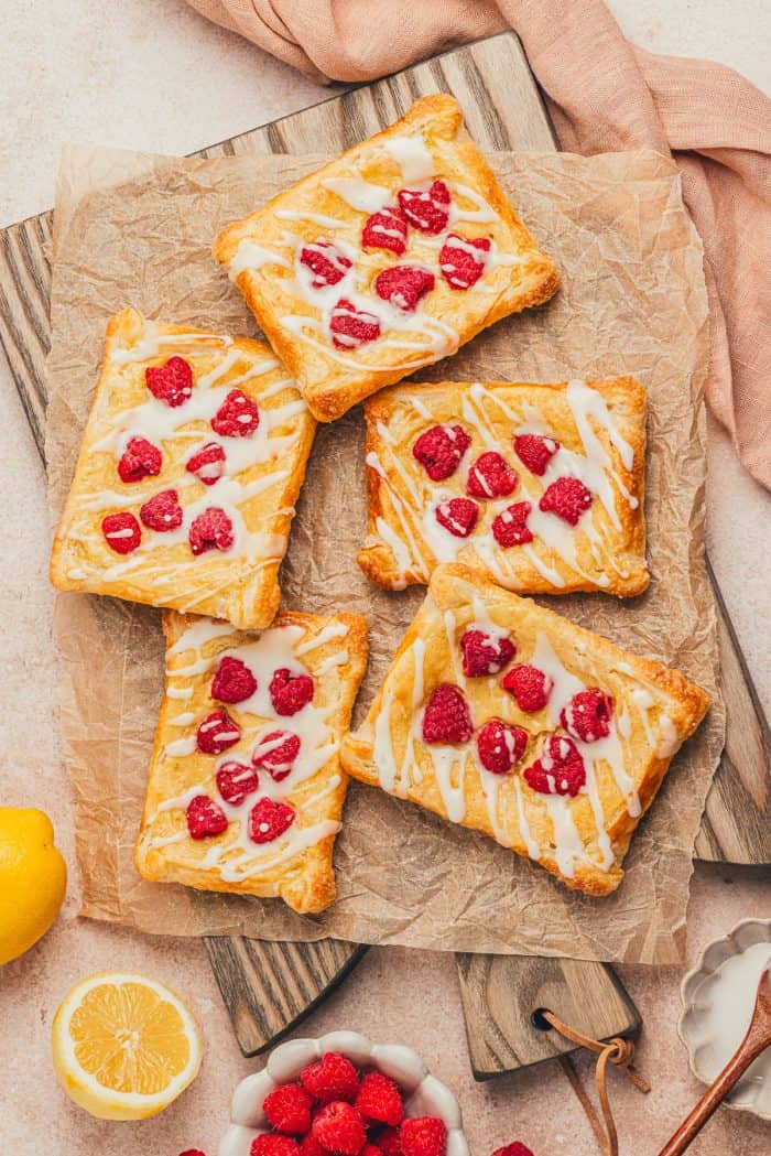 Homemade raspberry lemon cream cheese danishes stacked on each other.