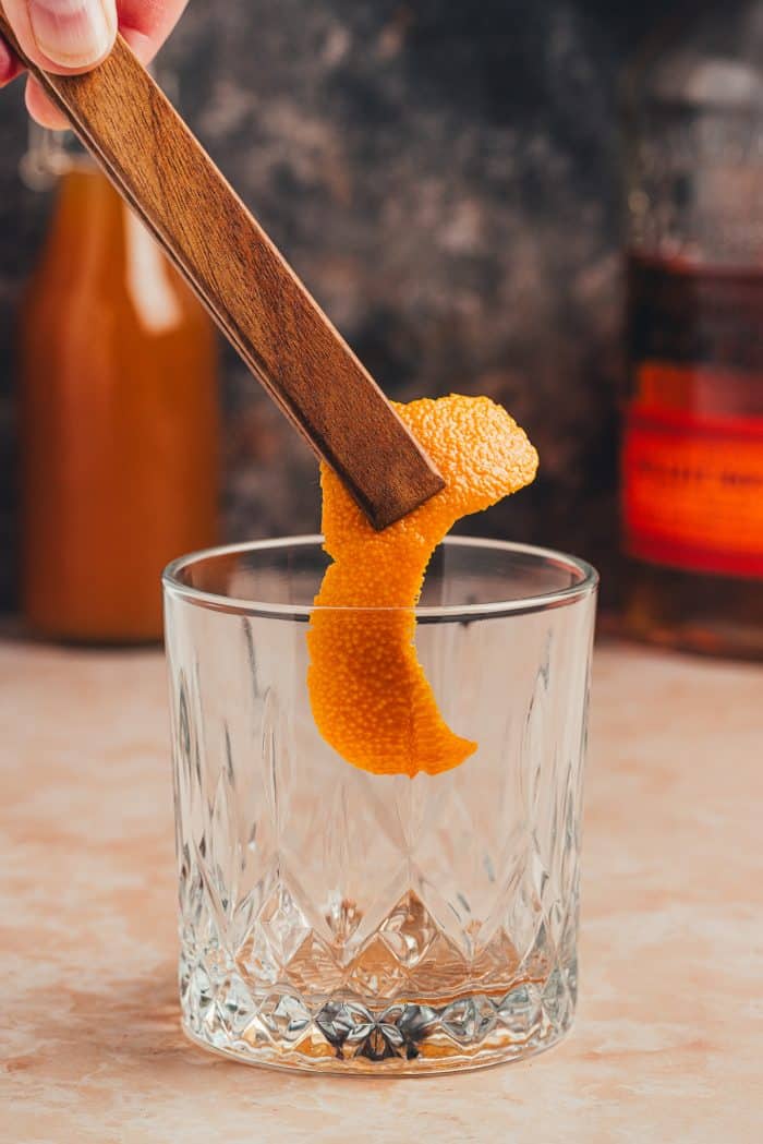 An orange peel added to a glass.