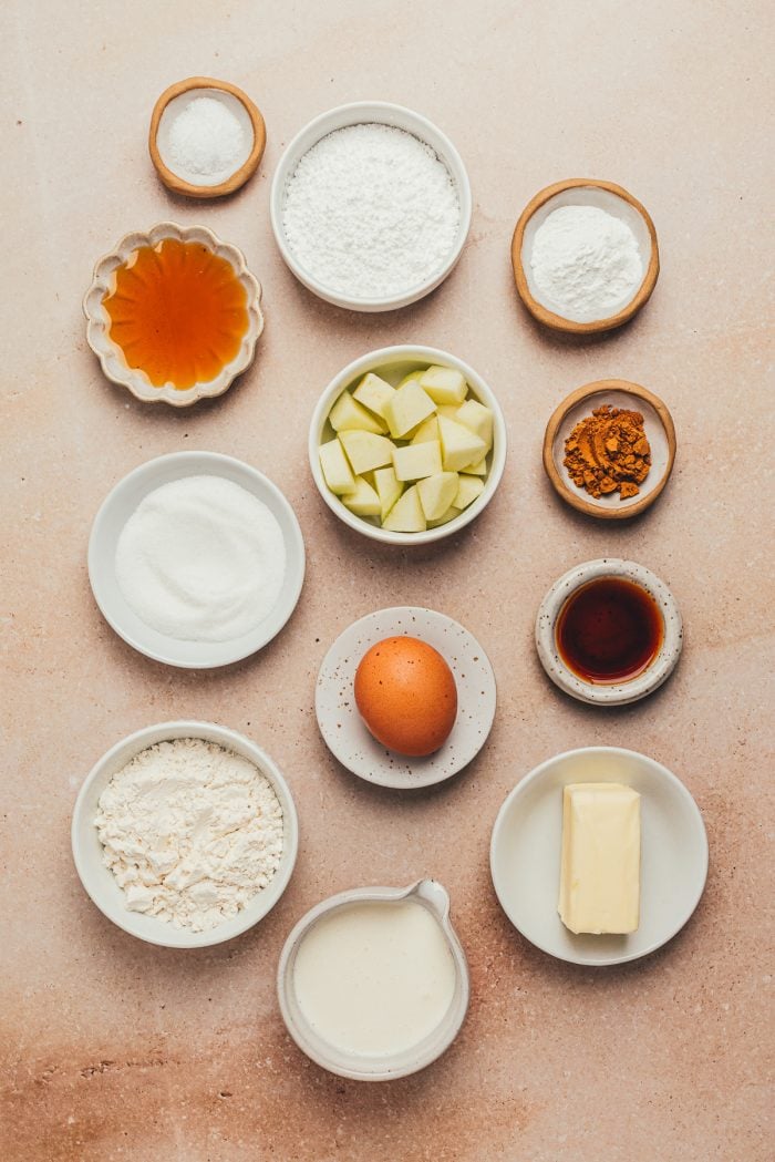 The ingredients for making apple cinnamon scones in various bowls.