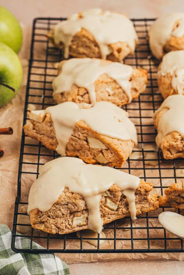 Apple cinnamon scones on a black cooling rack.