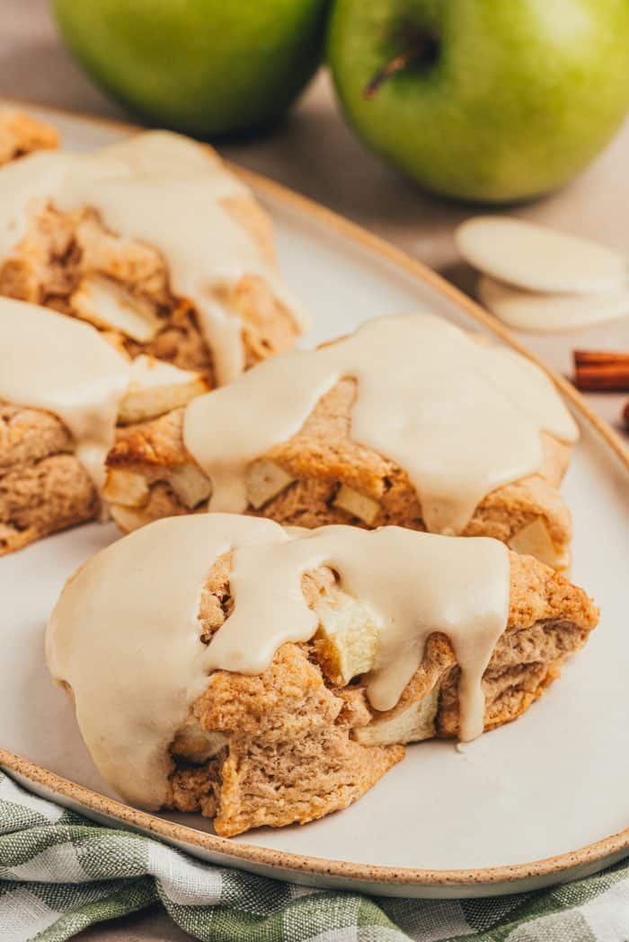 Four apple & cinnamon scones on a plate.
