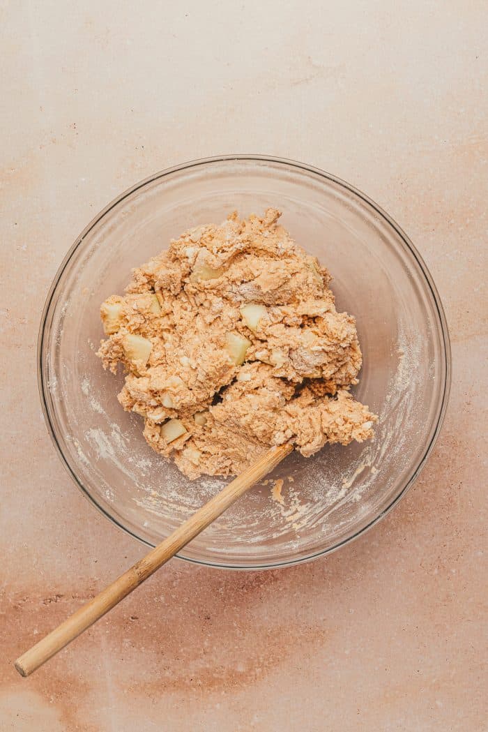 The dough for apple cinnamon scones in a glass mixing bowl.