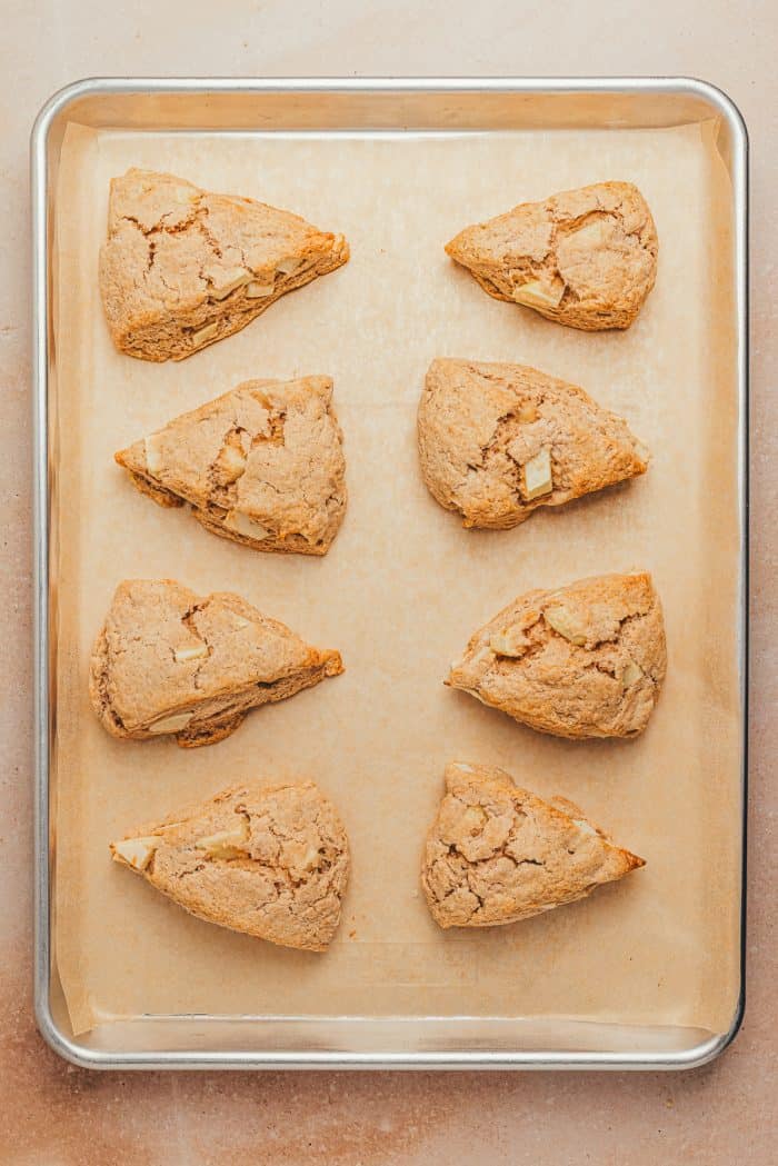 A baking tray with baked cinnamon apple scones. 