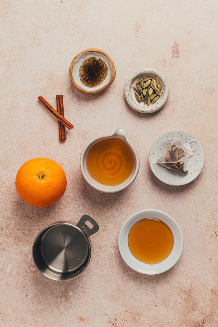 The ingredients to make a Chai hot toddy in various bowls.