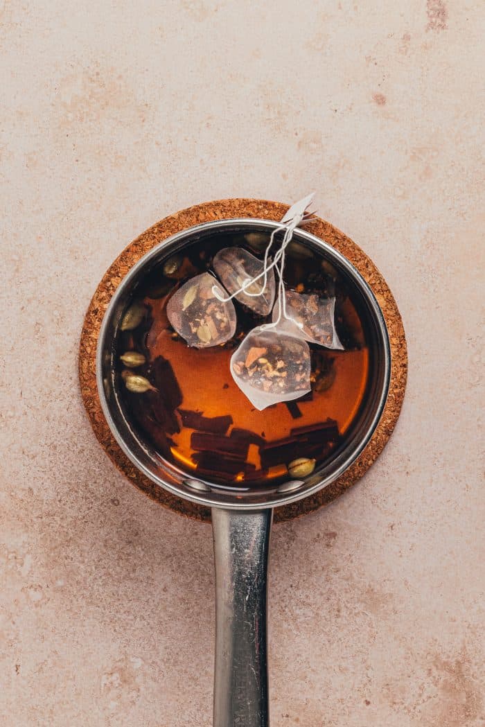 The chai tea steeping in a saucepan.