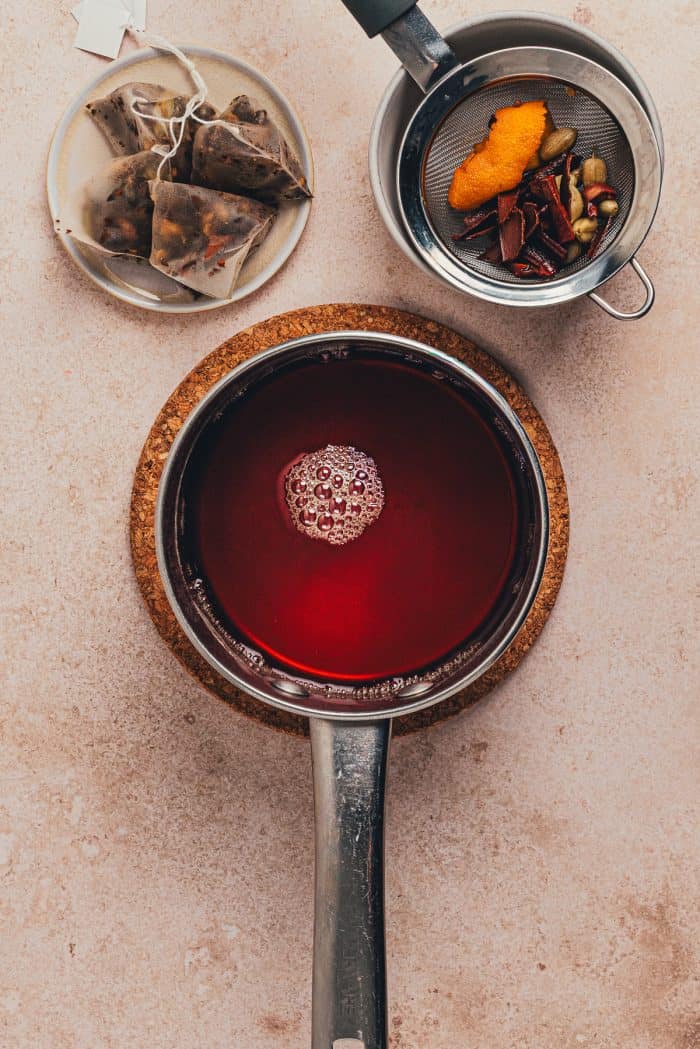 Water with hot toddy ingredients in a saucepan.
