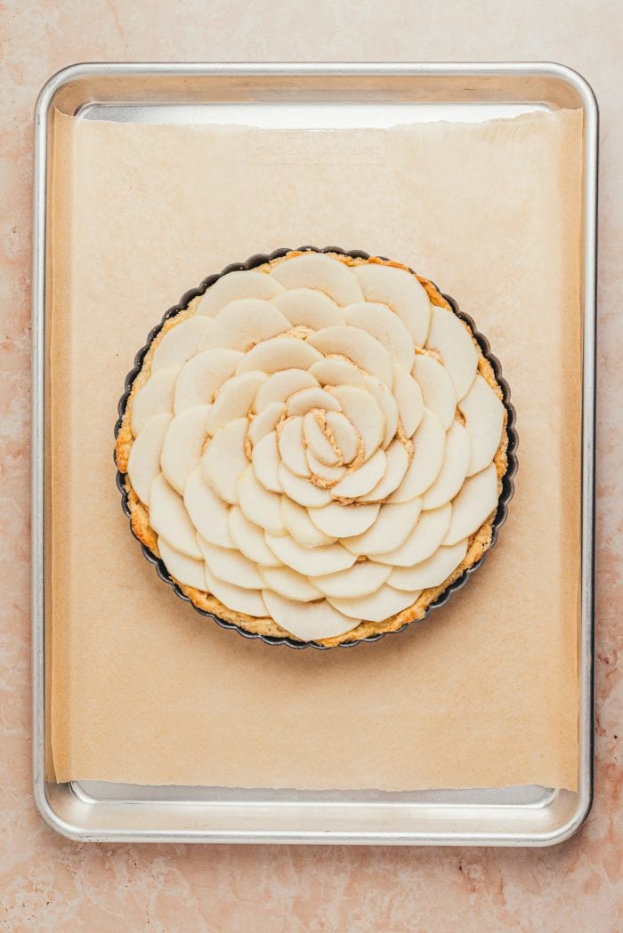 The sliced pears arranged on the tart shell.