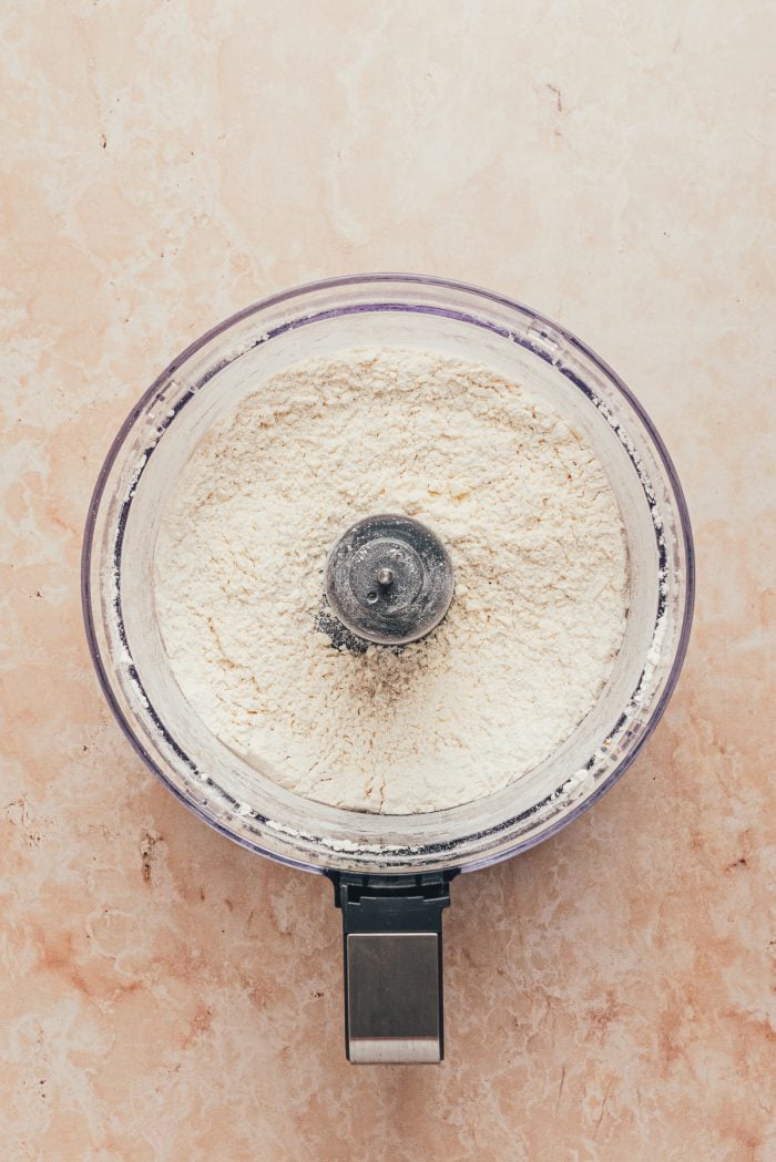 The dry ingredients for the tart shell in a food processor.