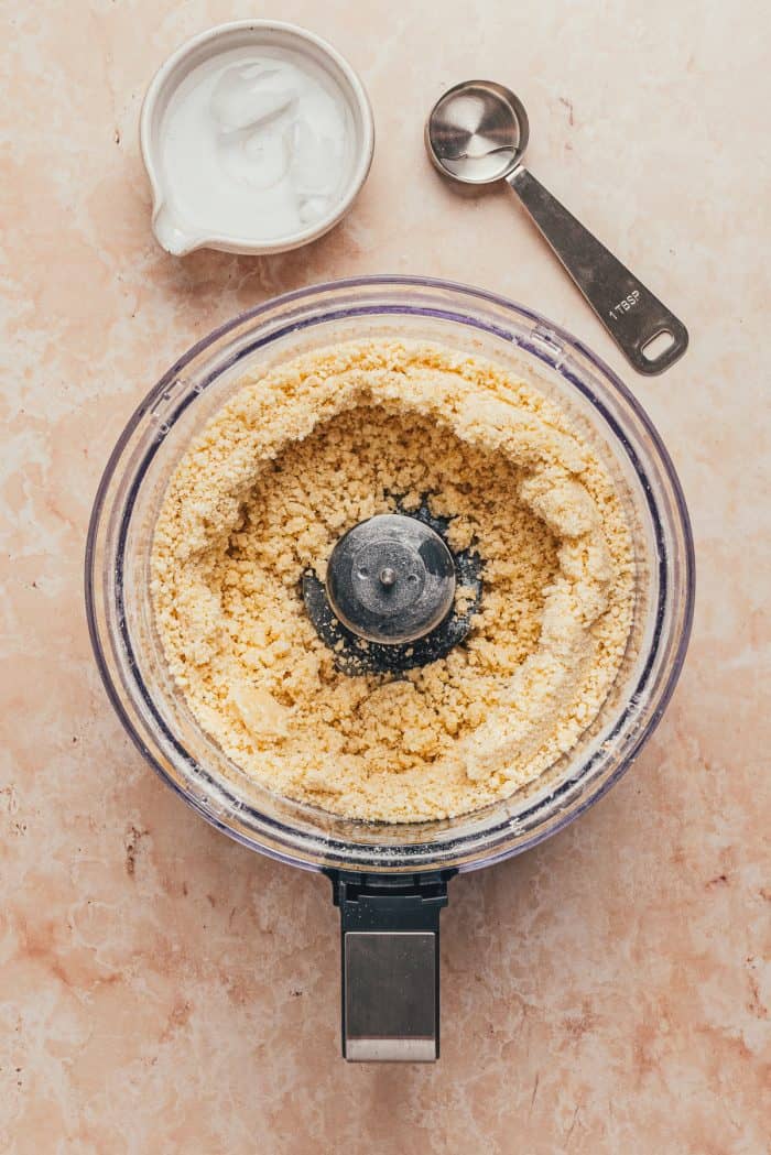 The dough for the tart shell in a food processor.