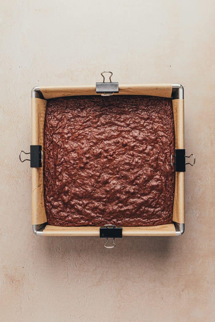 A square baking pan with baked brownies.