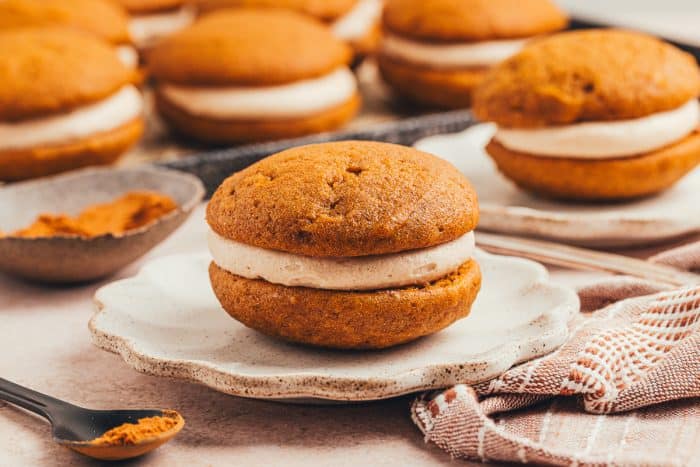 A pumpkin whoopie pie on a plate.