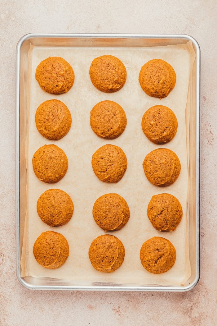 Baked whoopie pies on a baking sheet lined with parchment paper.