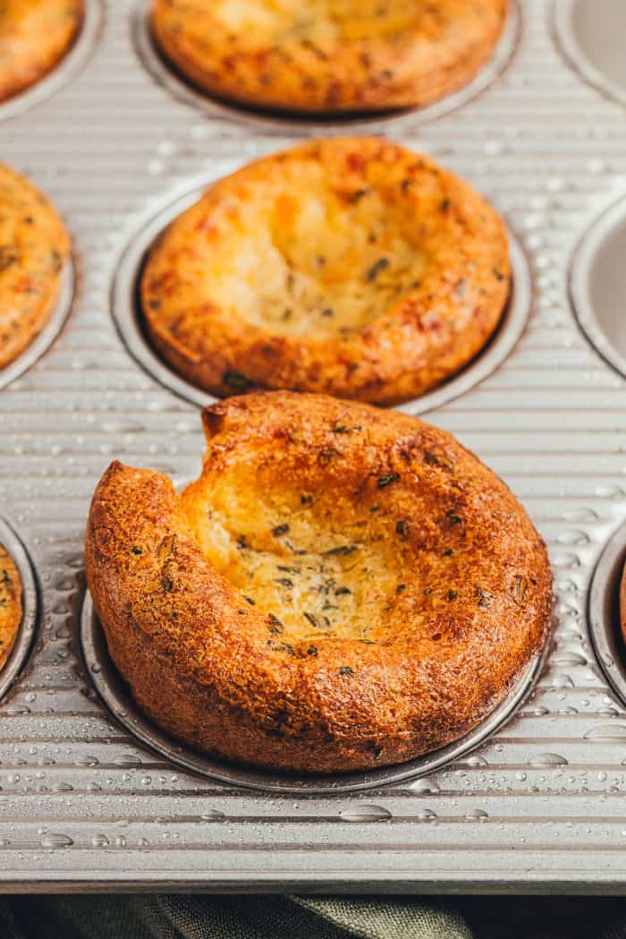 Herbed popovers in a baking tray.