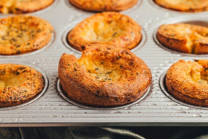 Herbed popovers in a baking tray.