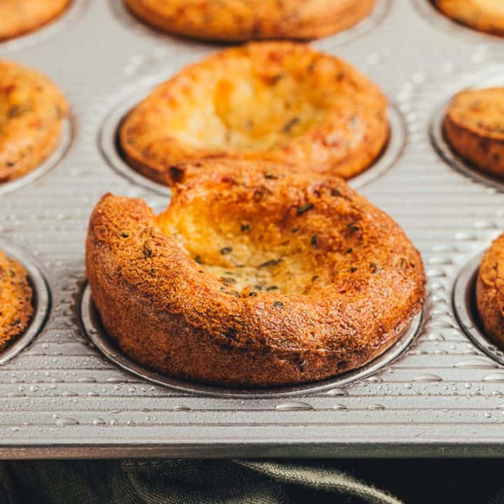 Herbed popovers in a baking tray.