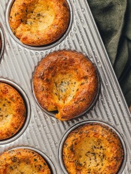 Herbed popovers in a baking tray.