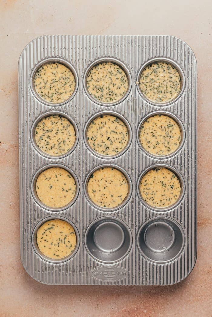 The popover batter poured into a cupcake pan.