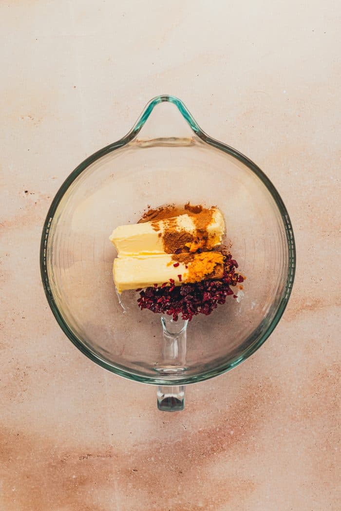 Butter, cranberry, and orange zest added to a large bowl.