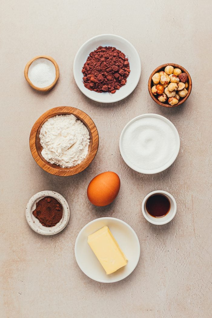Various bowls with the ingredients to make chocolate hazelnut slice and bake cookies.