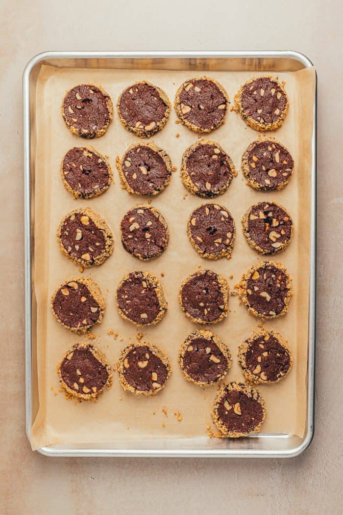 The baked chocolate shortbread cookies on a parchment paper lined baking sheet.