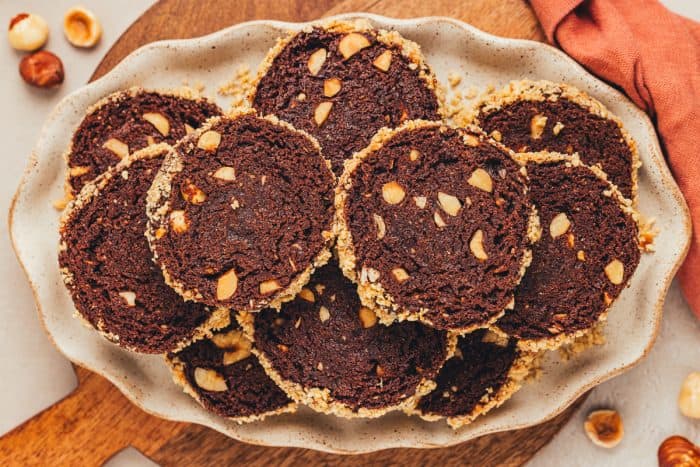 A plate with chocolate slice and bake cookies.