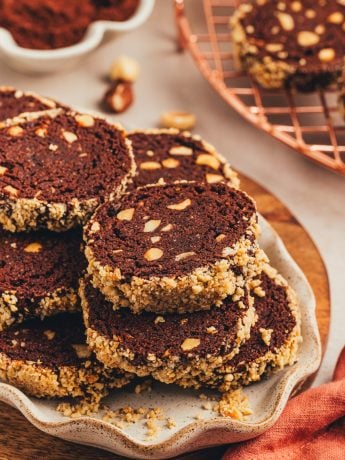 A plate with chocolate slice and bake cookies.