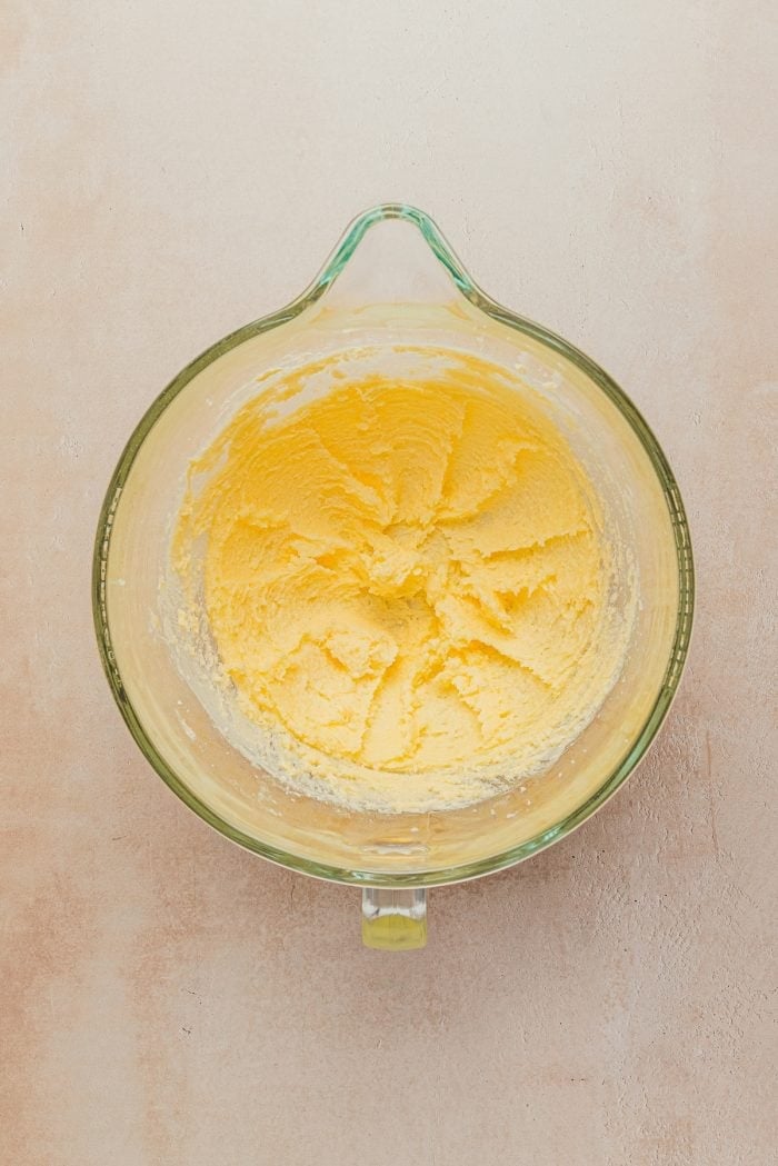 Butter and sugar in a bowl mixed together.