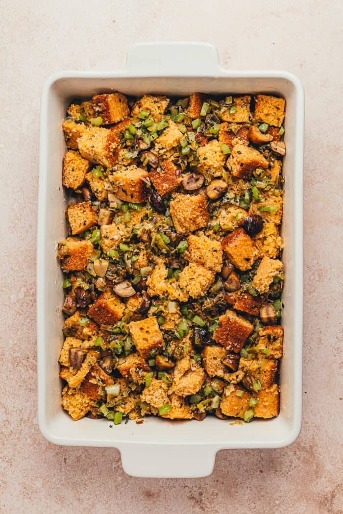 A white rectangle baking dish with unbaked stuffing.