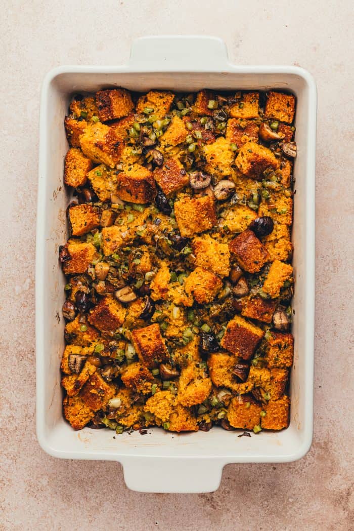A white rectangle baking dish with baked stuffing.