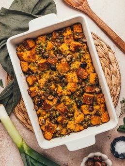 A white rectangle baking dish with baked stuffing.
