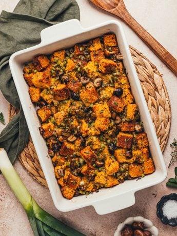 A white rectangle baking dish with baked stuffing.