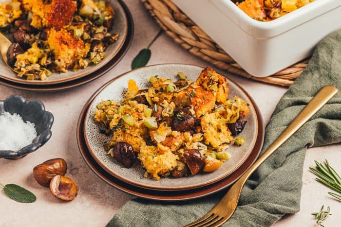 A small plate with a serving of stuffing made with cornbread.