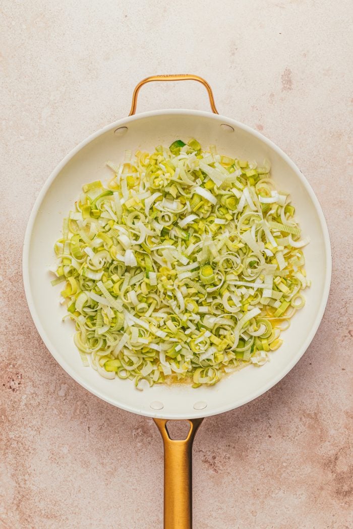 Sliced leeks in a skillet.