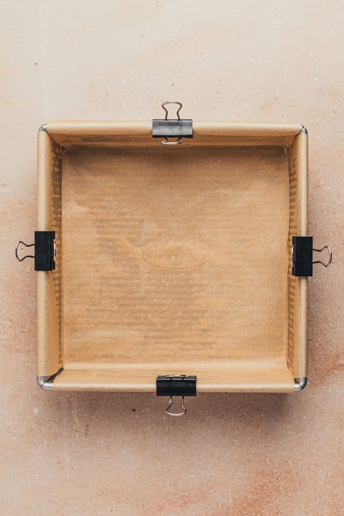 A square baking pan with parchment paper.