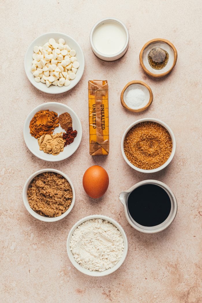 Various bowls with the ingredients for making gingerbread Thumbprint cookies.