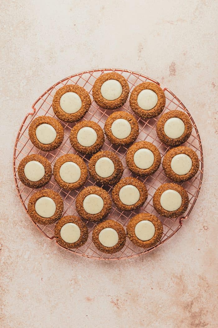 The filled thumbprint cookies cooling on a cooling rack.